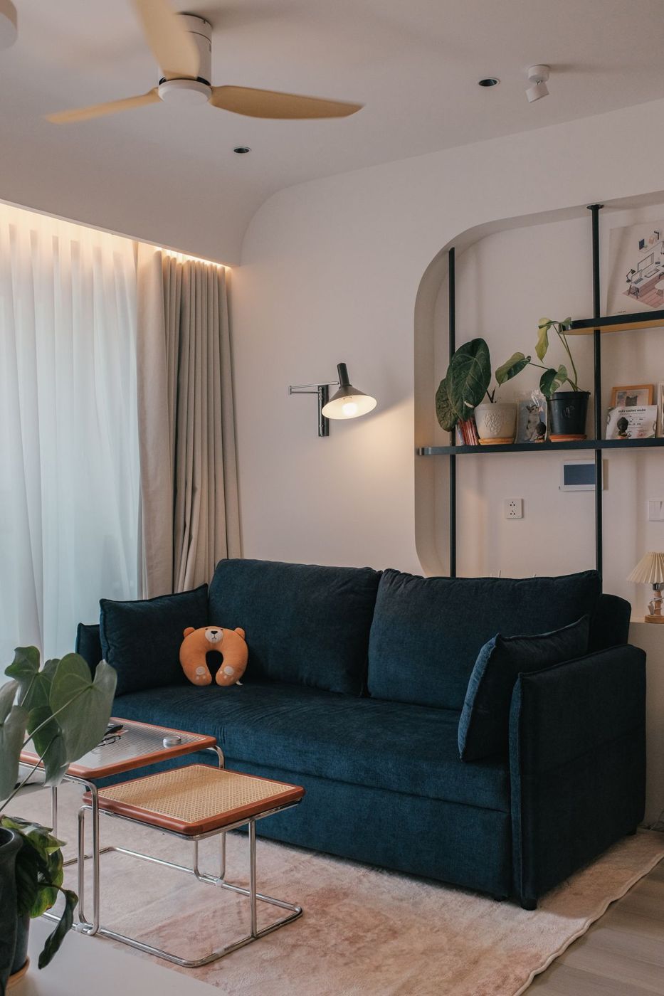 Clean living room with a green sofa and rug